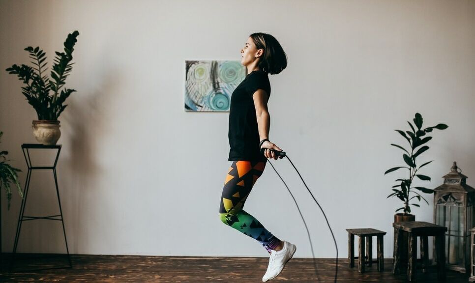 Girl doing exercise with skipping rope