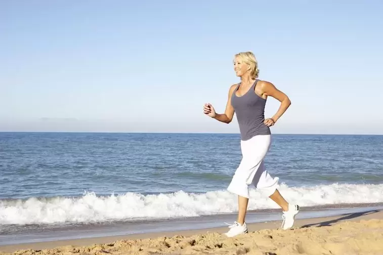 An elderly woman jogging for weight loss and good heart function